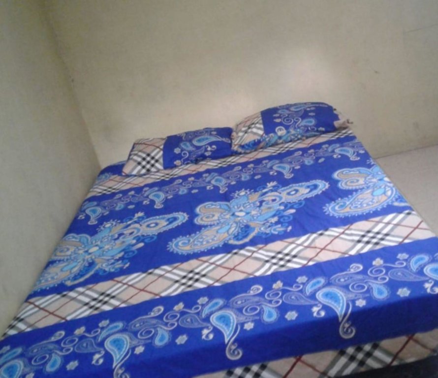 Кровать в общем номере Gerbang Banyu Langit Cottage