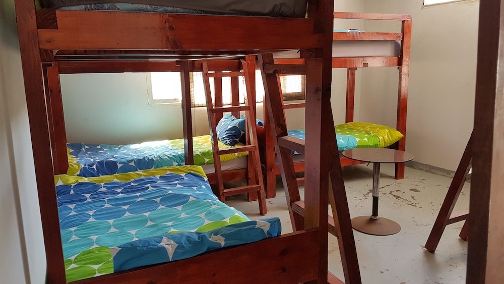 Кровать в общем номере Catembe Beach Lodge