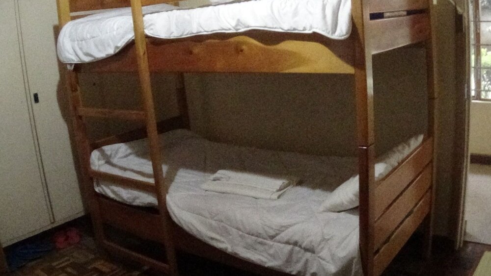 Кровать в общем номере Kolping Guest House
