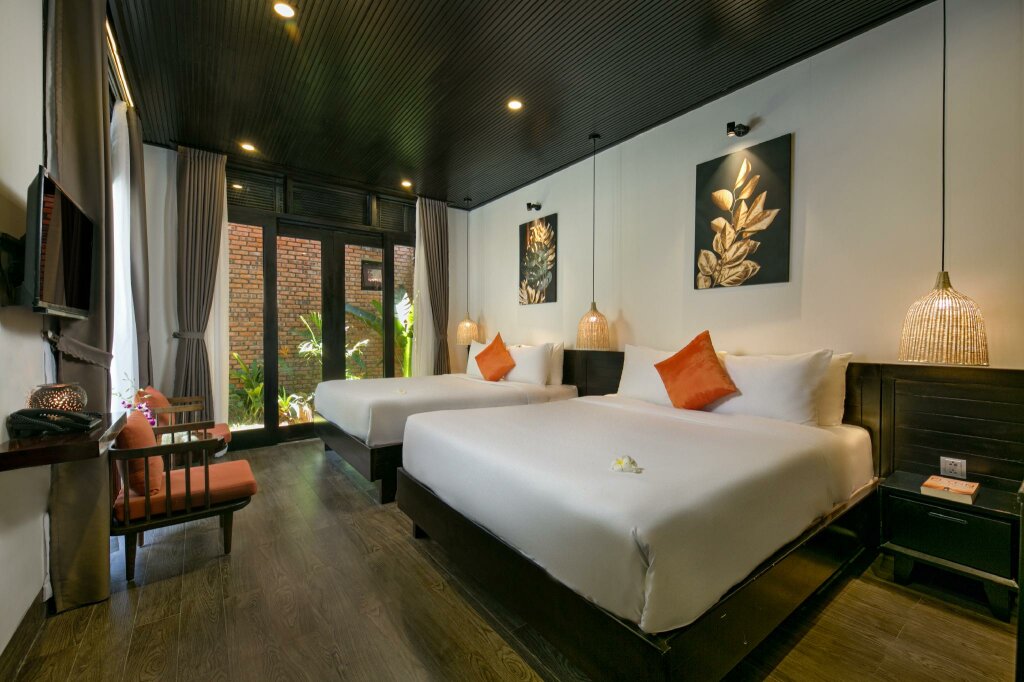 Standard Quadruple Family room with balcony and with garden view MAI Villa Da Nang