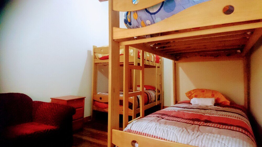 Кровать в общем номере Kuna del Inka Hospedaje