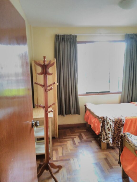 Cama en dormitorio compartido Huaypo House & Lodging