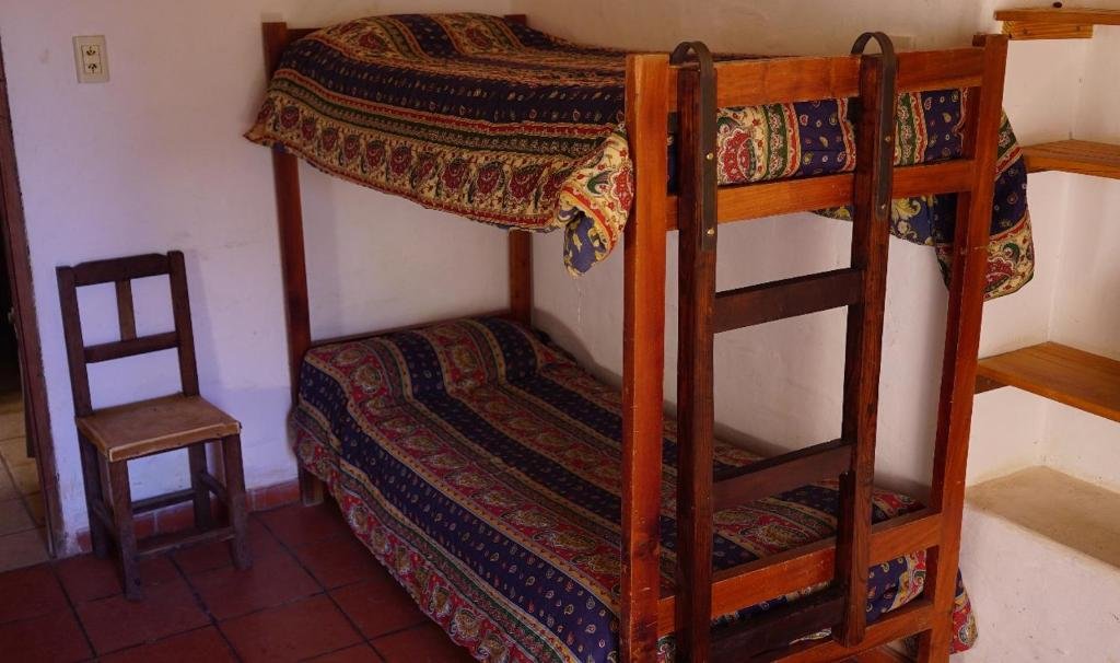 Кровать в общем номере Capec Alojamiento