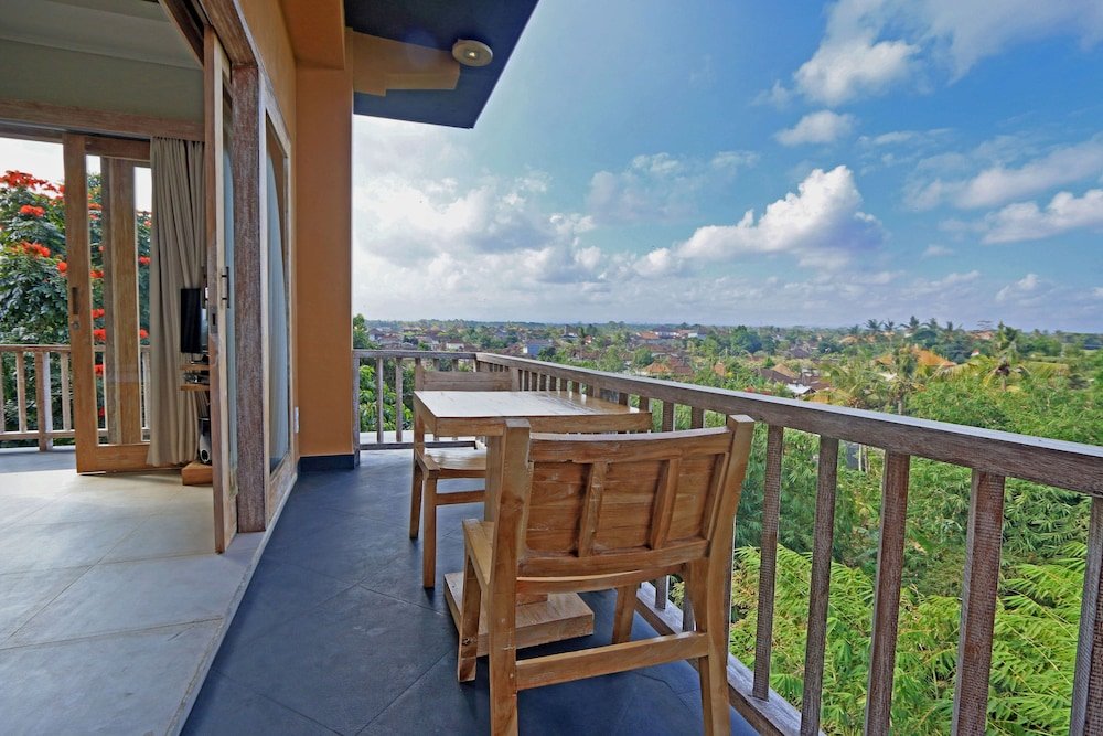 Suite junior 1 dormitorio con balcón y con vista al jardín KajaNe Yangloni at Ubud Bali