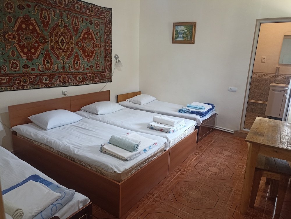 Cama en dormitorio compartido con balcón IRIS mini hotel