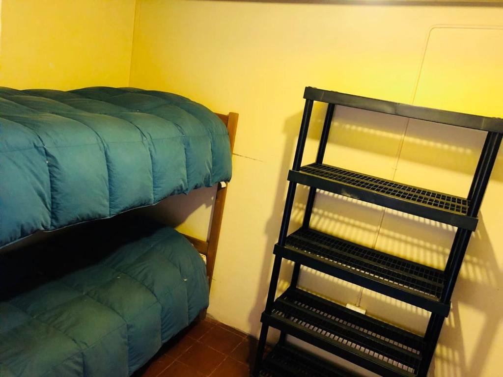 Кровать в общем номере Hostal Intipara