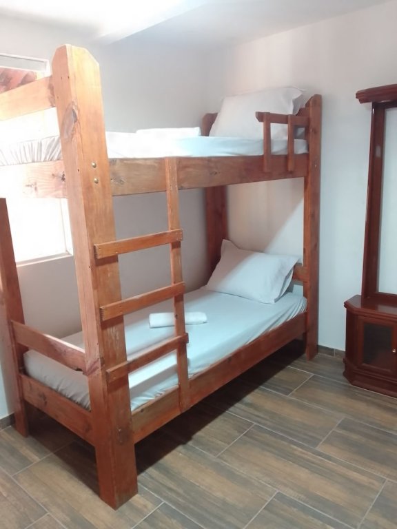 Кровать в общем номере Pousada Vale dos Ventos