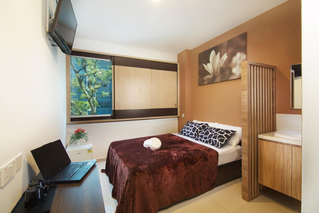 Кровать в общем номере Tai Hoe Hotel