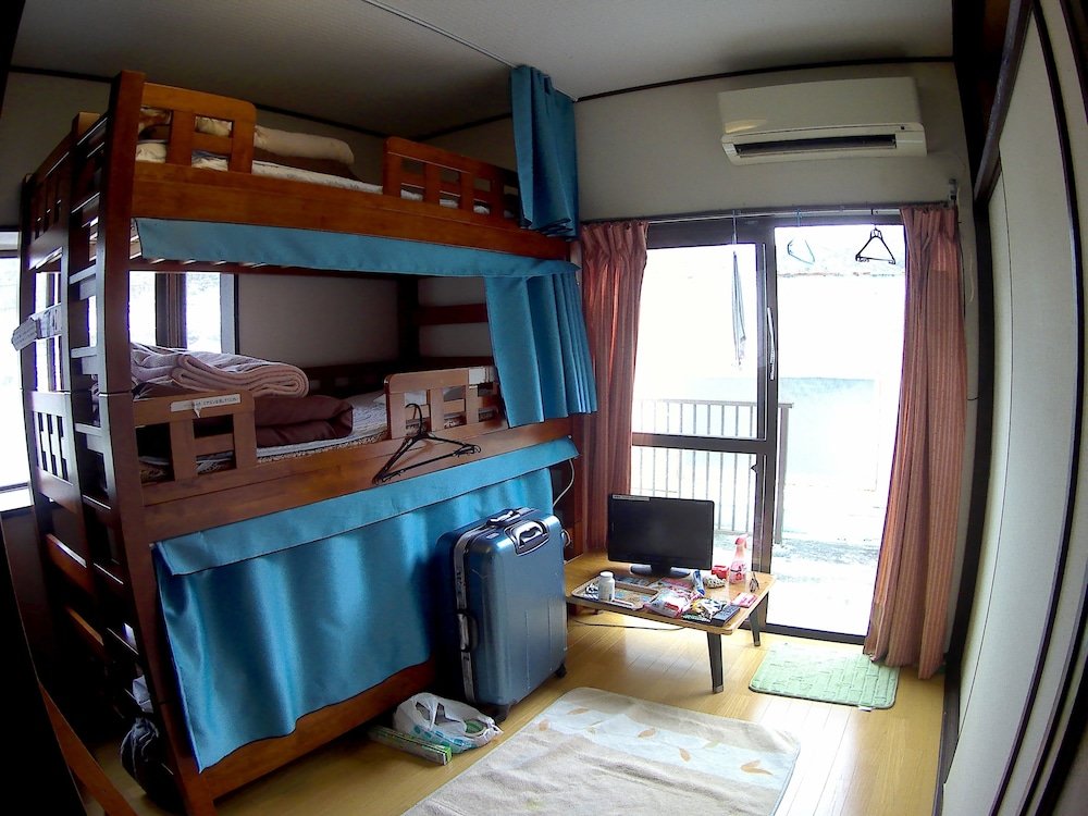 Cama en dormitorio compartido (dormitorio compartido masculino) GUEST HOUSE IN AMAMI RYOUFUU - Hostel
