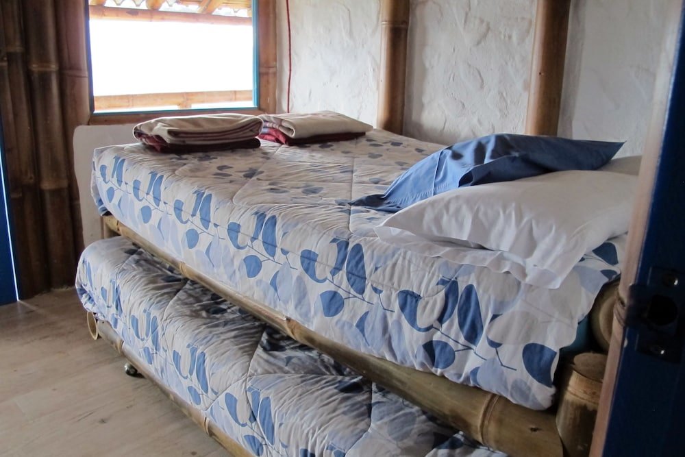 Cama en dormitorio compartido Urku Wasi Ecolodge