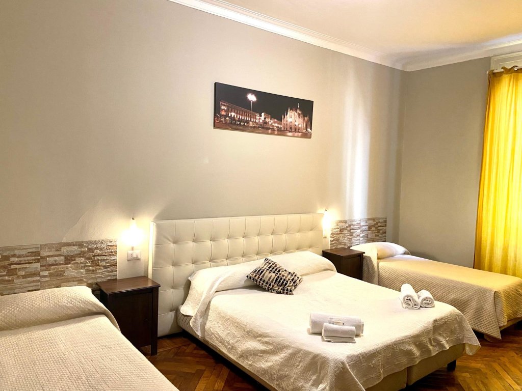 Кровать в общем номере Carlo Goldoni Hotel