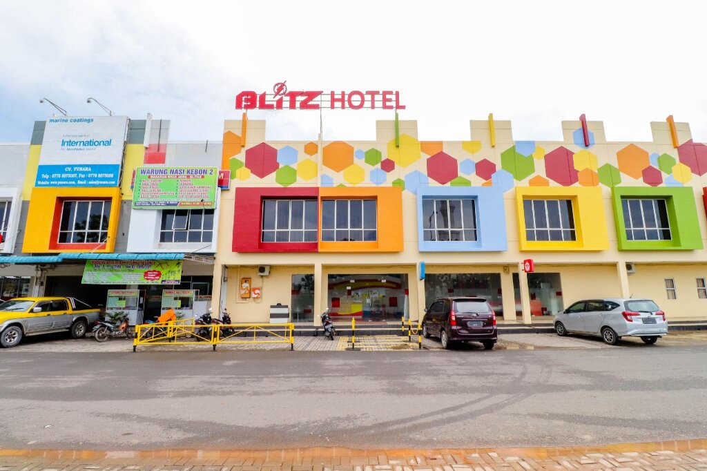 Кровать в общем номере Blitz Hotel Batam Tanjung Uncang