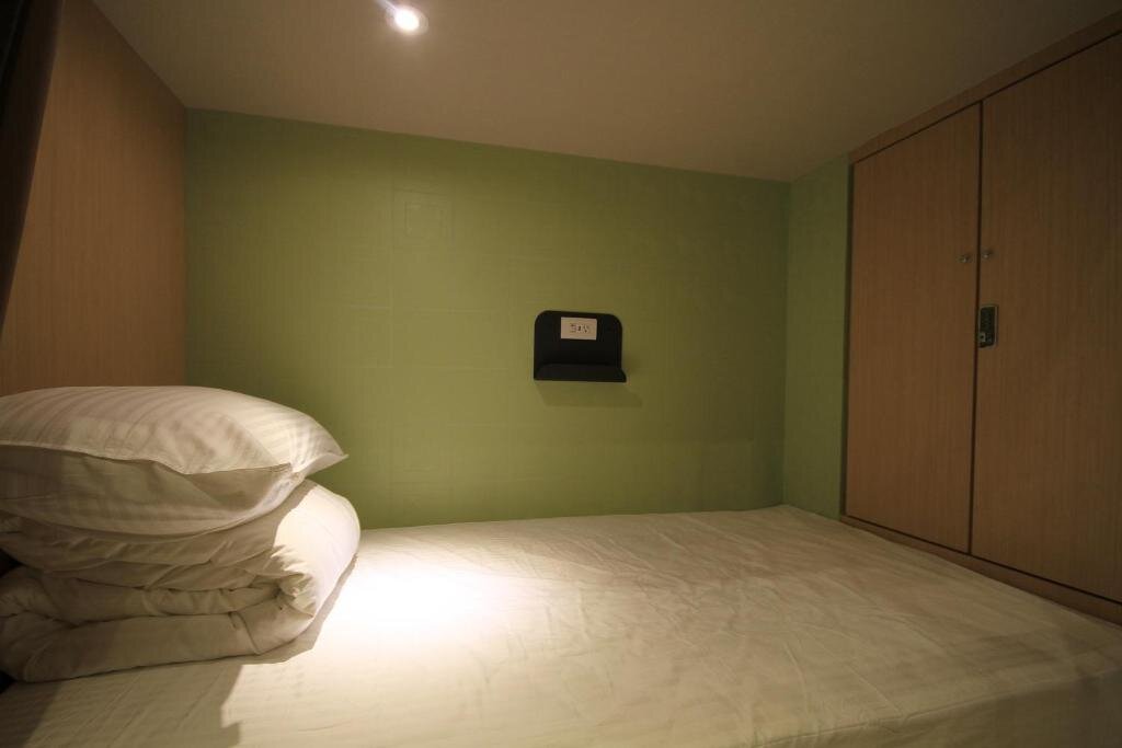Кровать в общем номере Hangkhau Hotel