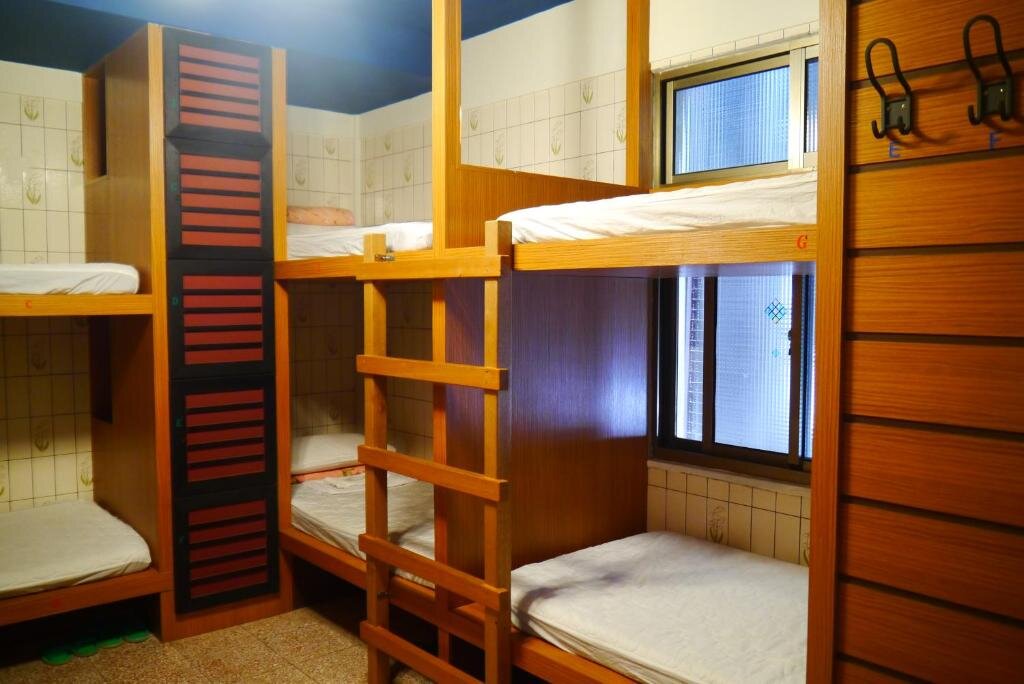 Кровать в общем номере Hsin Hsin Hotel