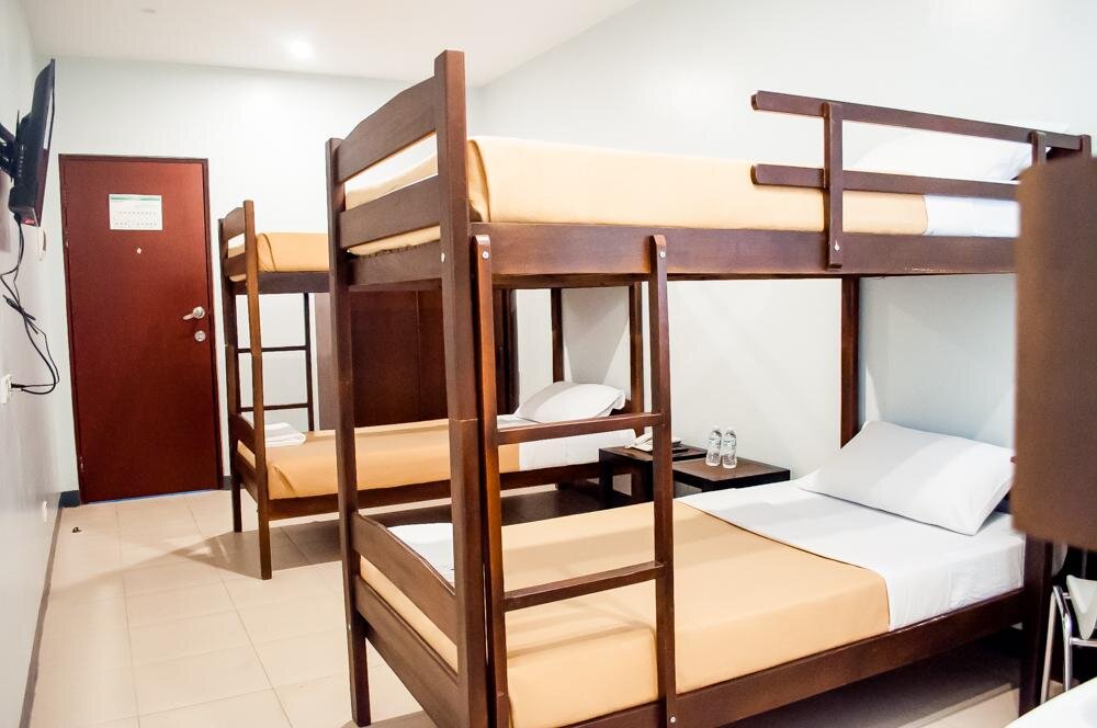 Кровать в общем номере Seasons Hotel Sablayan