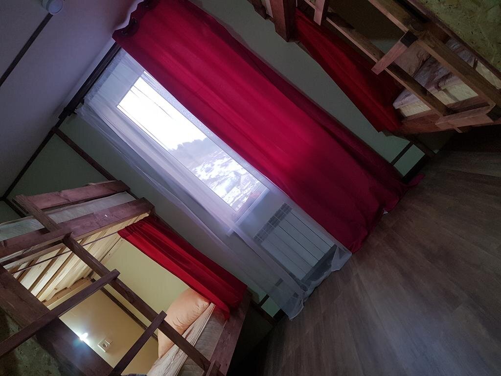Кровать в общем номере с красивым видом из окна Burka Hostel